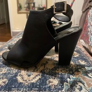 Black heels with peakaboo toe and silver buckle